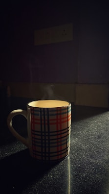 A cozy ceramic mug with a unique, hand-drawn pattern glowing in natural light.
