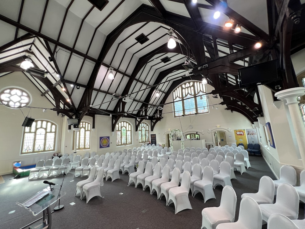 a room with rows of white chairs