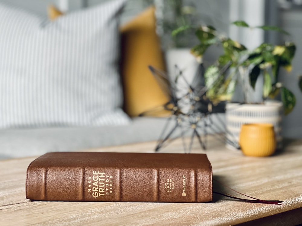 a wallet with a yellow pillow on a table