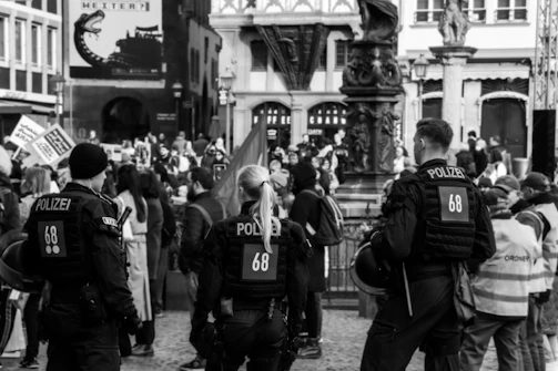 Security team managing crowd control at a large outdoor event in Berlin.