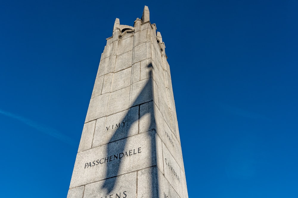 a stone tower with a sign on it