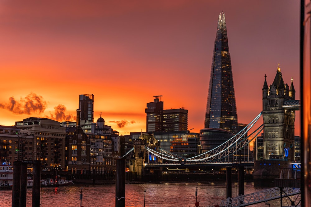 a city skyline with a bridge and a river