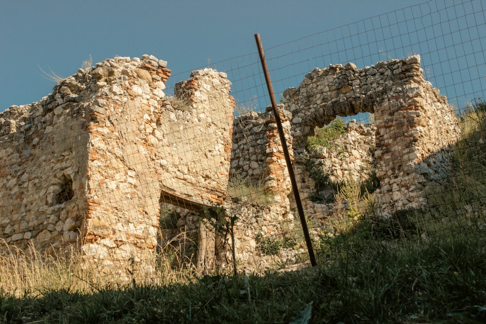a stone building with a fence