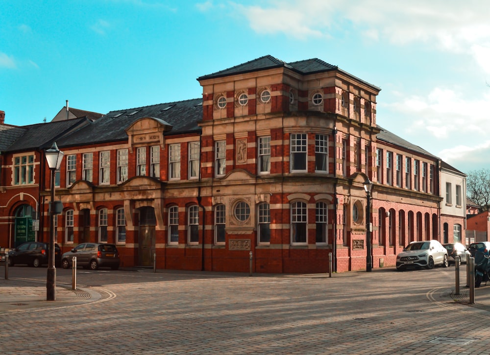 a brick building with cars parked in front of it