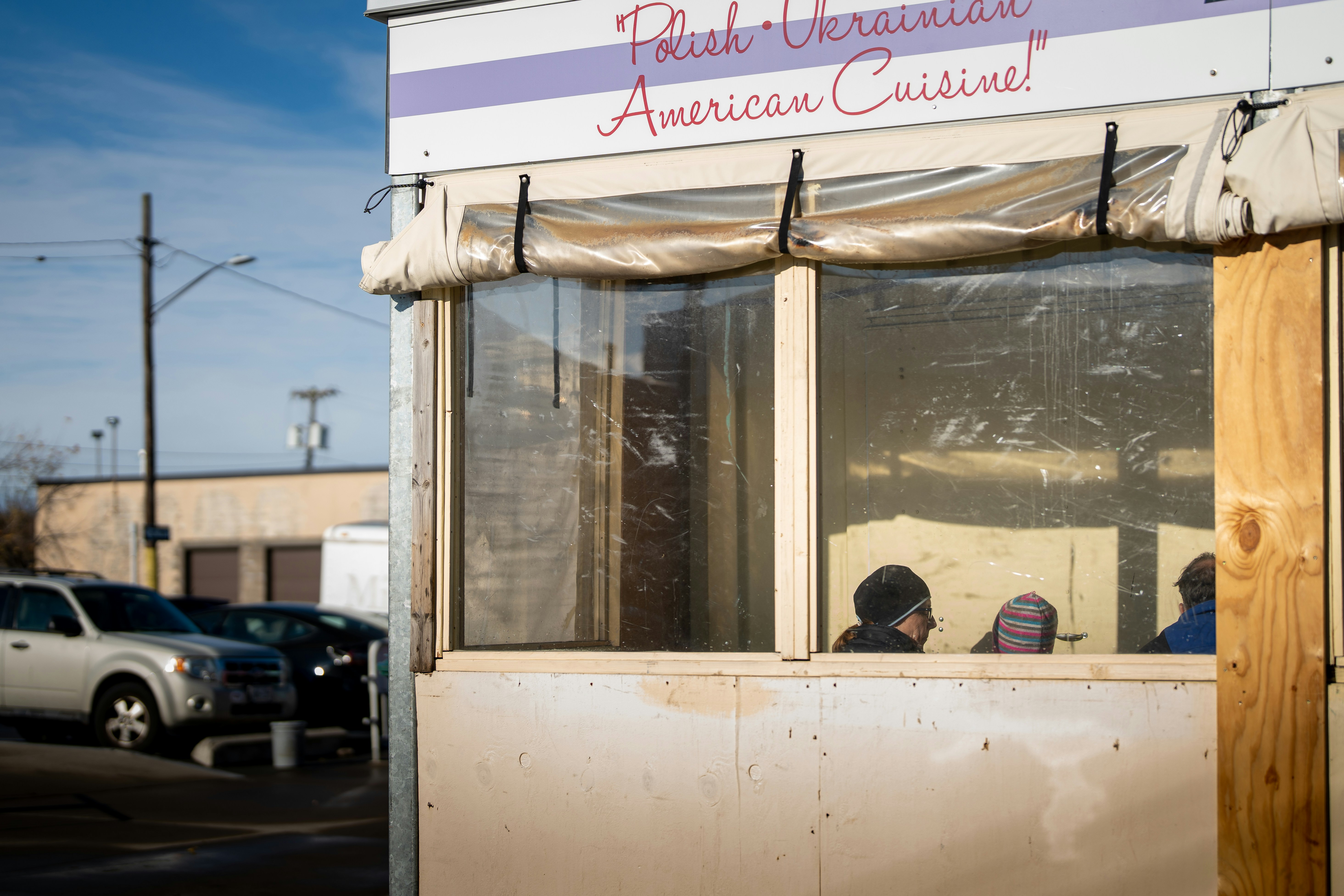 a person sitting in a small food truck