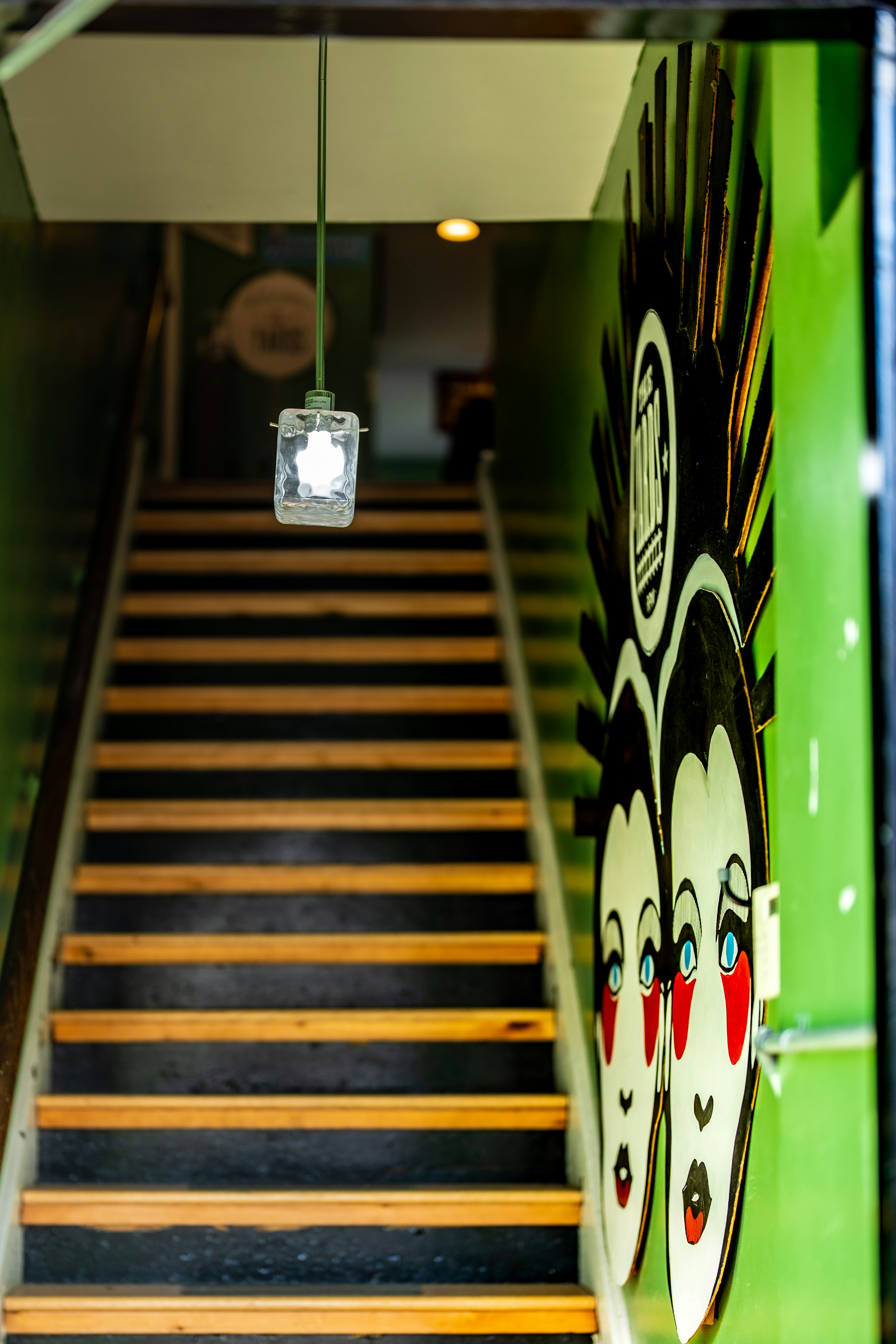 a staircase with a green wall