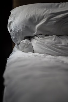 a white pillow on a bed
