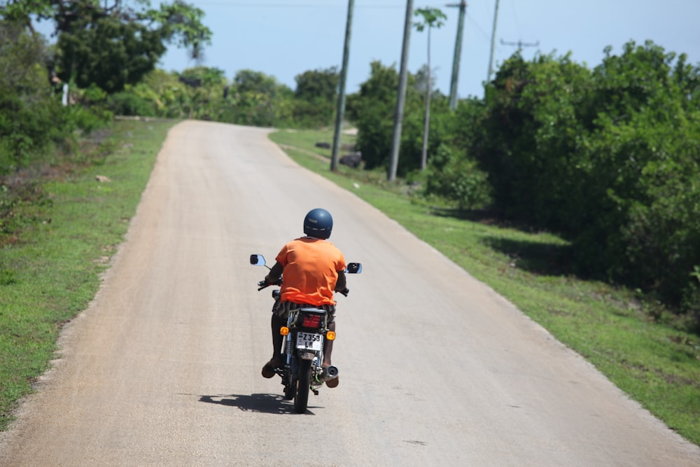 a man riding a motorcycle on a road