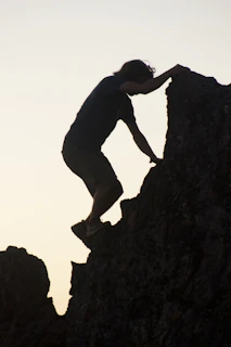a man climbing a rock