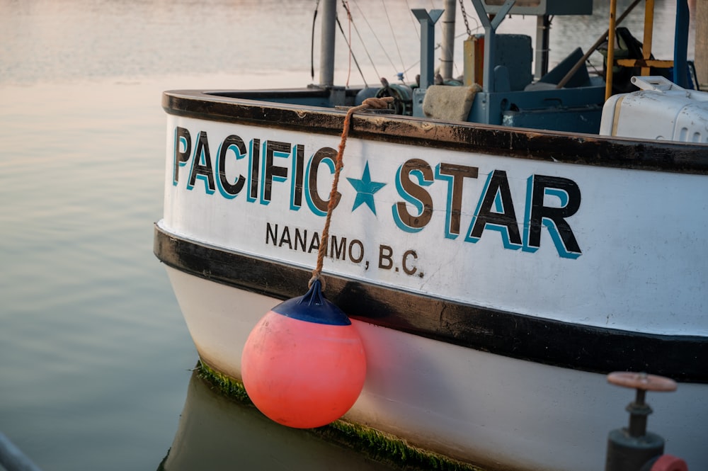 a boat with a red ball in front of it