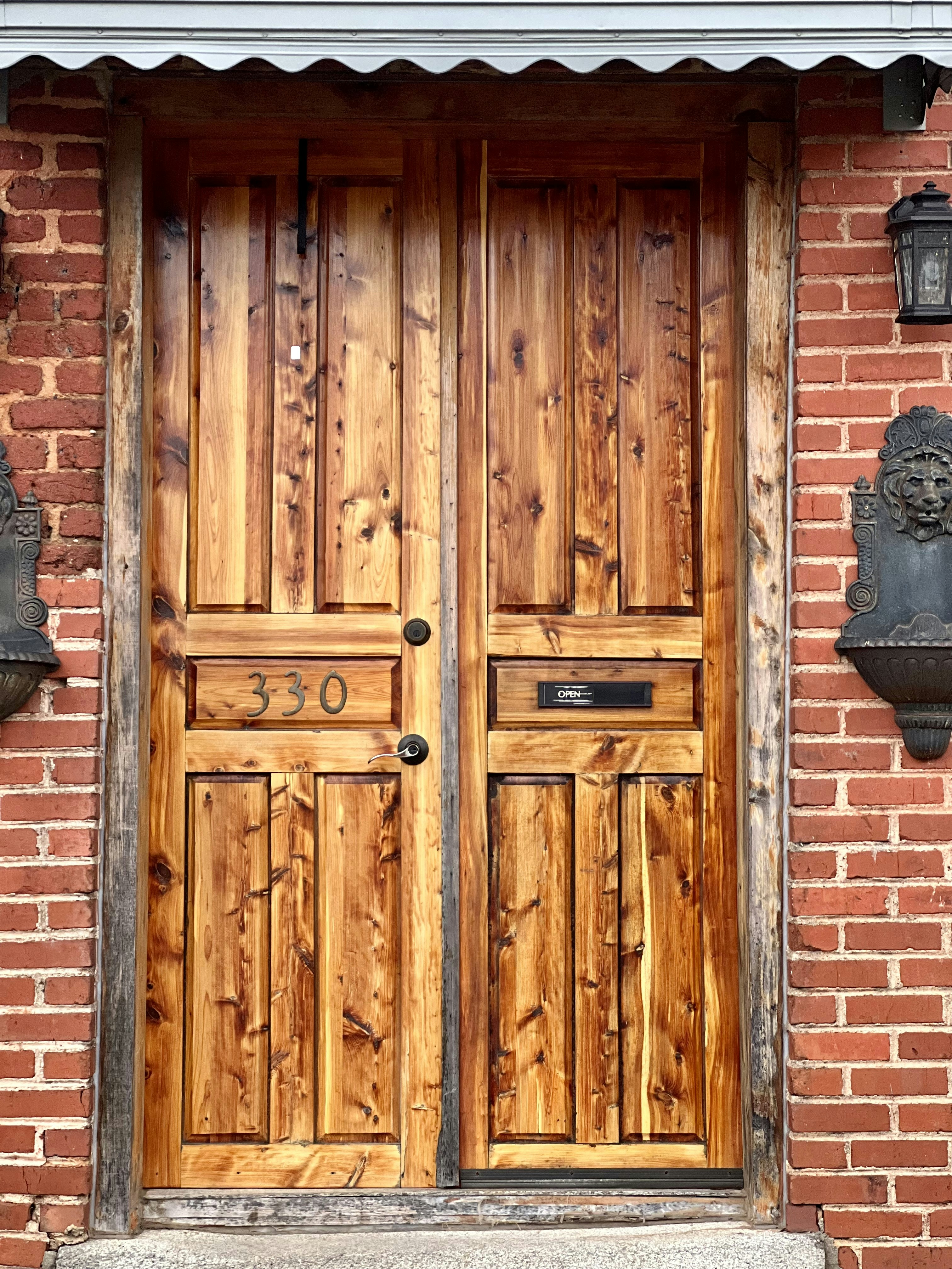 a wooden door on a brick building