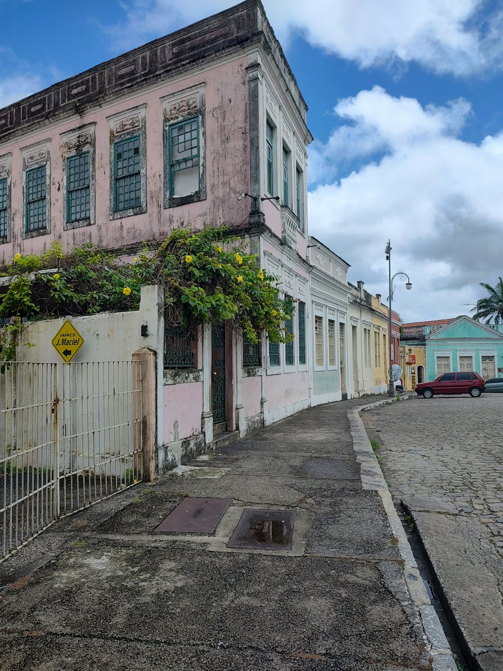 a street with a fence and buildings