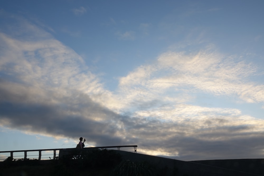 a person sitting on a railing