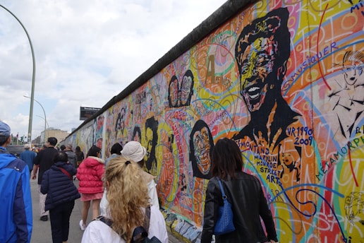 A colorful group of children exploring a vibrant Chicago neighborhood mural on a sunny day.