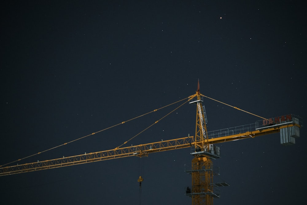 a large yellow crane at night