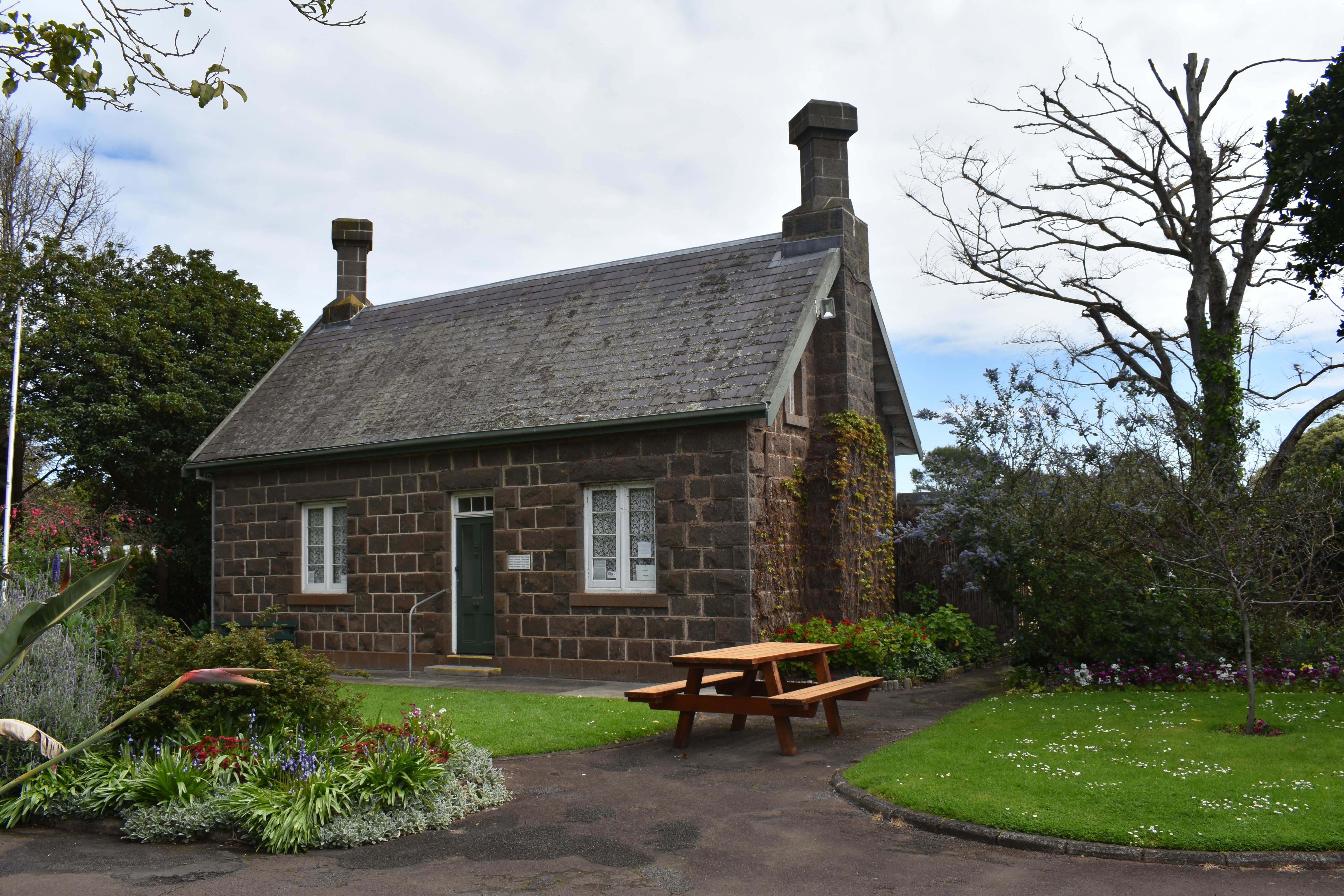 a brick house with a picnic table