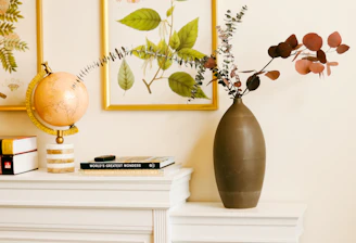 a vase with flowers on a shelf