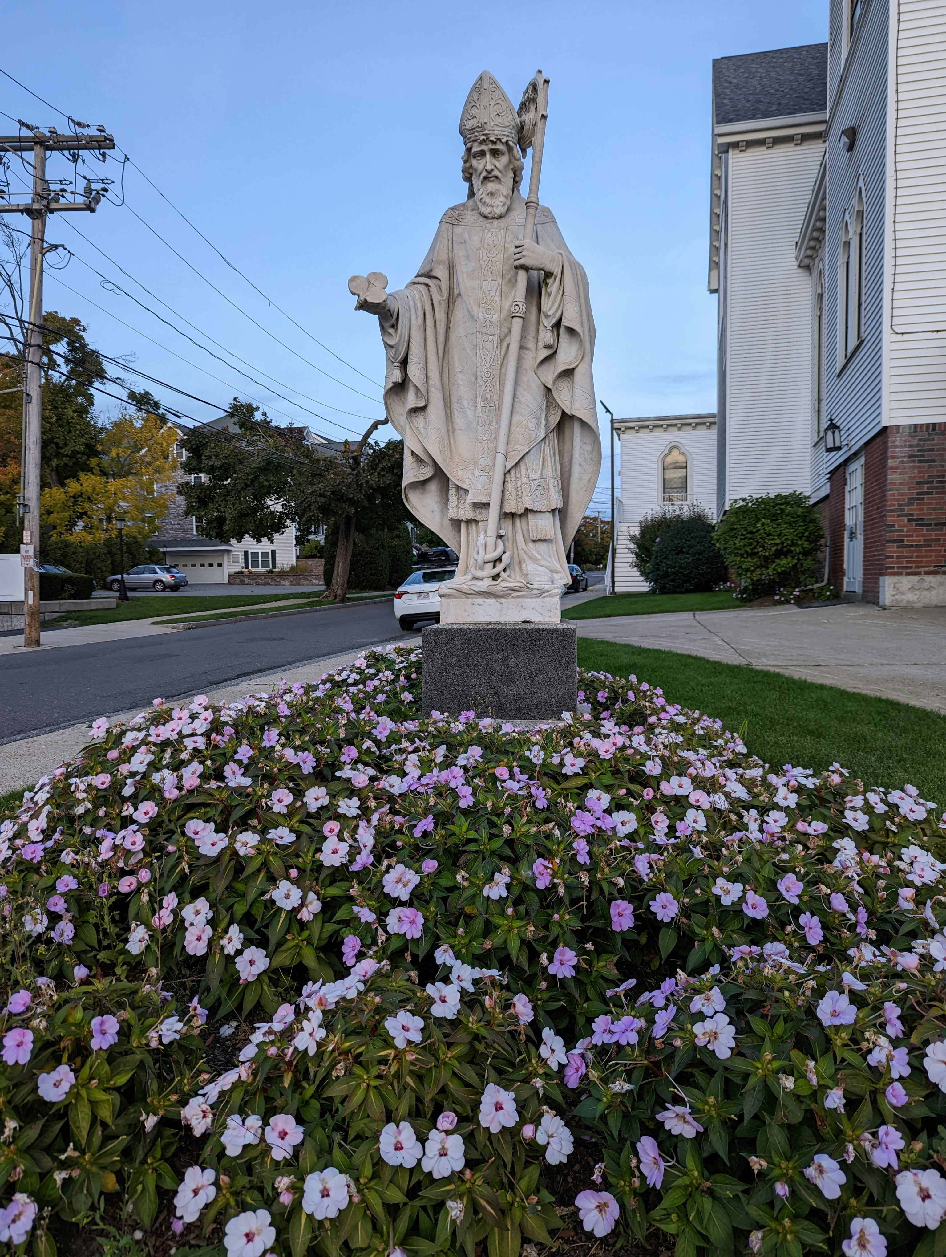 a statue of a person holding a torch in a garden