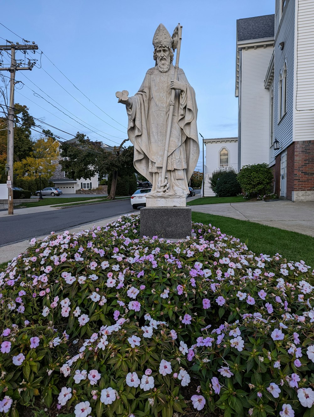 a statue of a person holding a torch in a garden