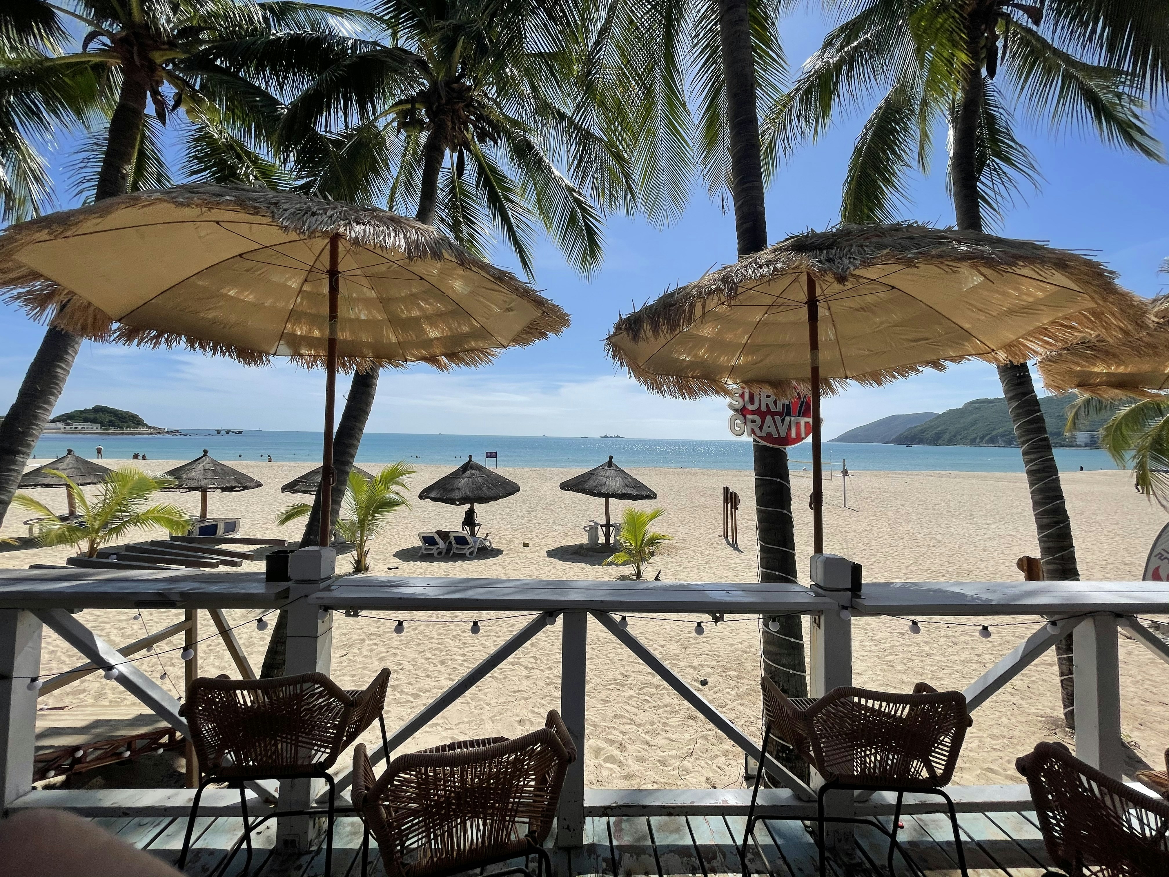 a beach with umbrellas and chairs
