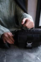 Close-up of a secure malote bag being handled carefully by a staff member.