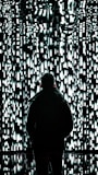 a person standing in front of a wall of lights