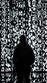 a person standing in front of a wall of lights