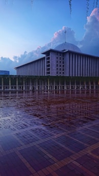 A serene mosque courtyard in Taiwan bathed in soft morning light, with worshippers arriving for prayer.