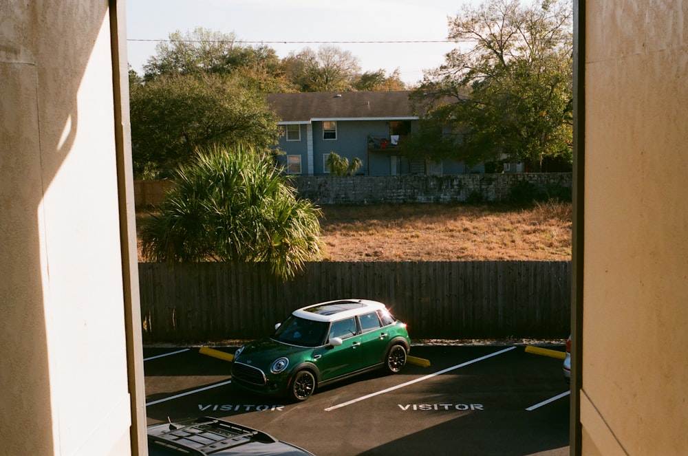a green car parked in a driveway