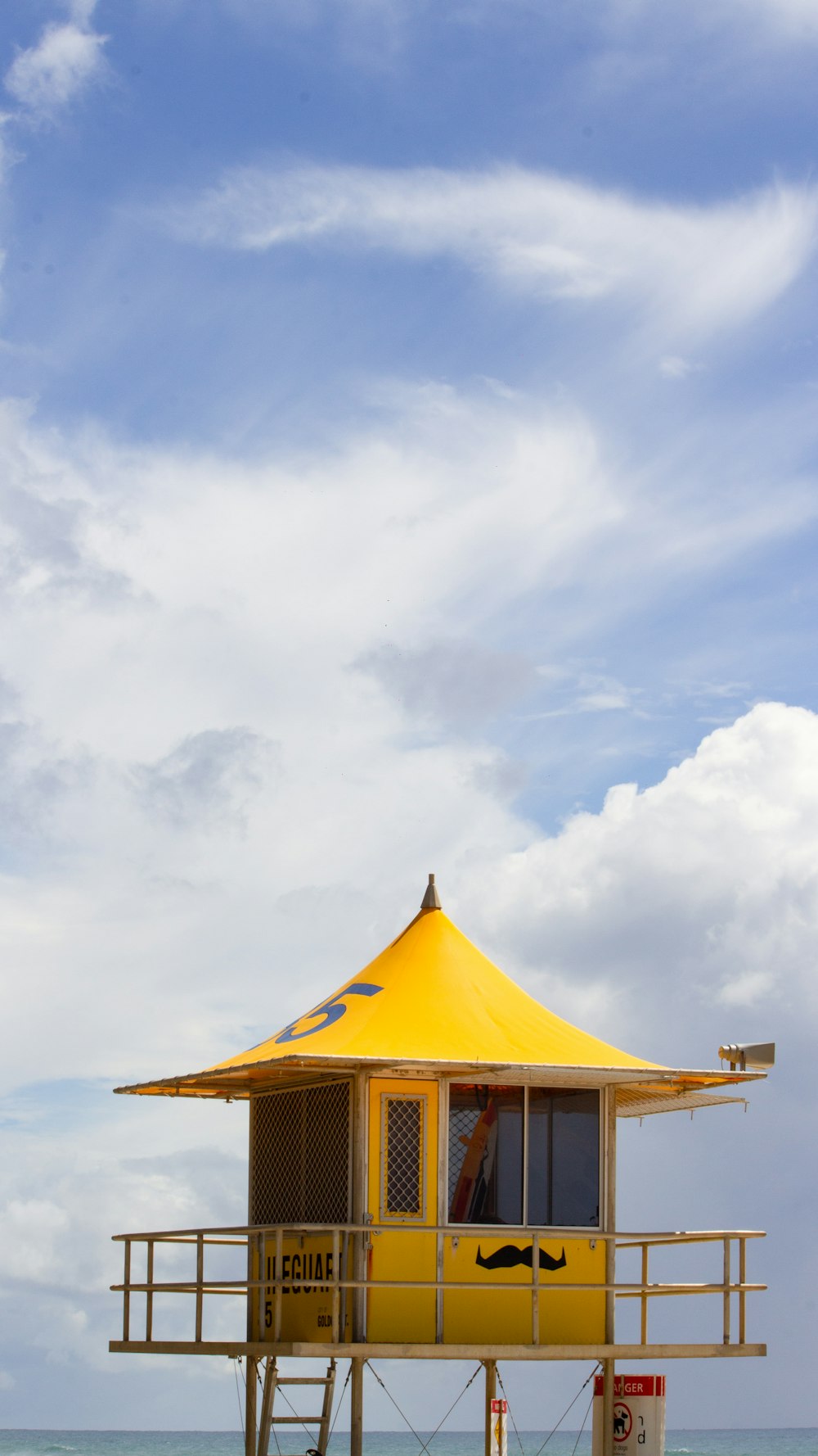 a yellow house on a beach