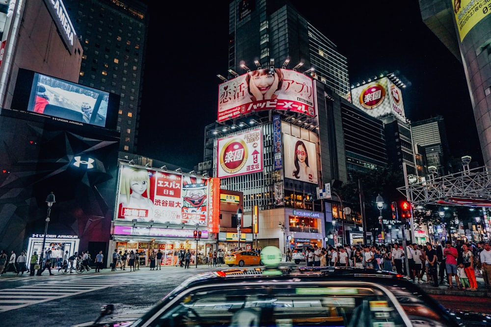 a busy city street with Times Square in the background