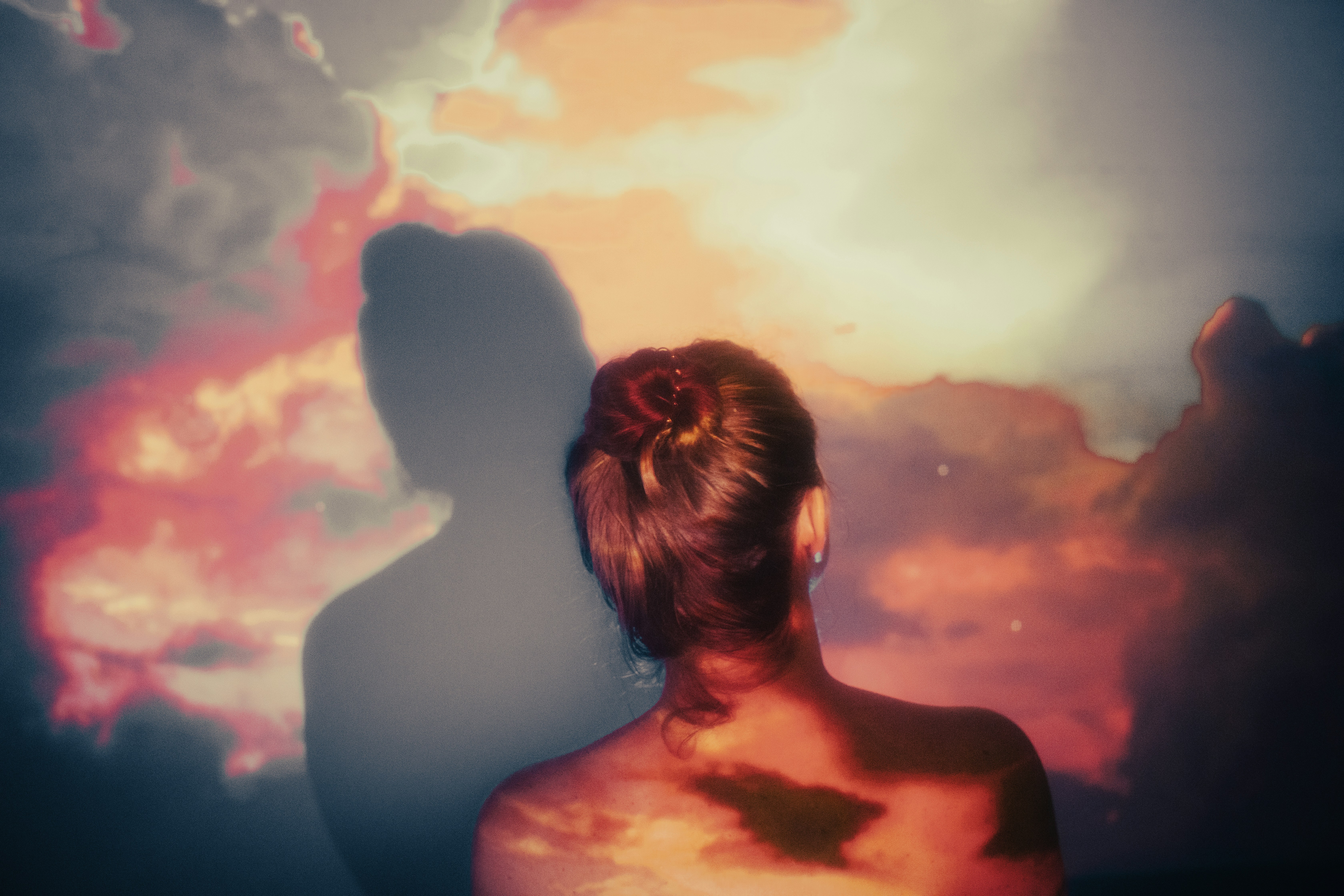 a person looking at a sunset