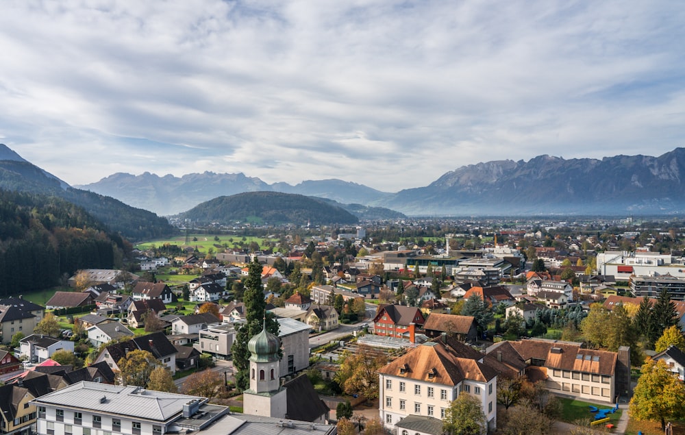 a city with many buildings and mountains in the background