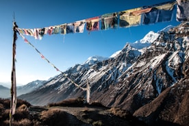 a group of people from a rope over a mountain