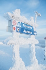 a street sign on a snow covered post