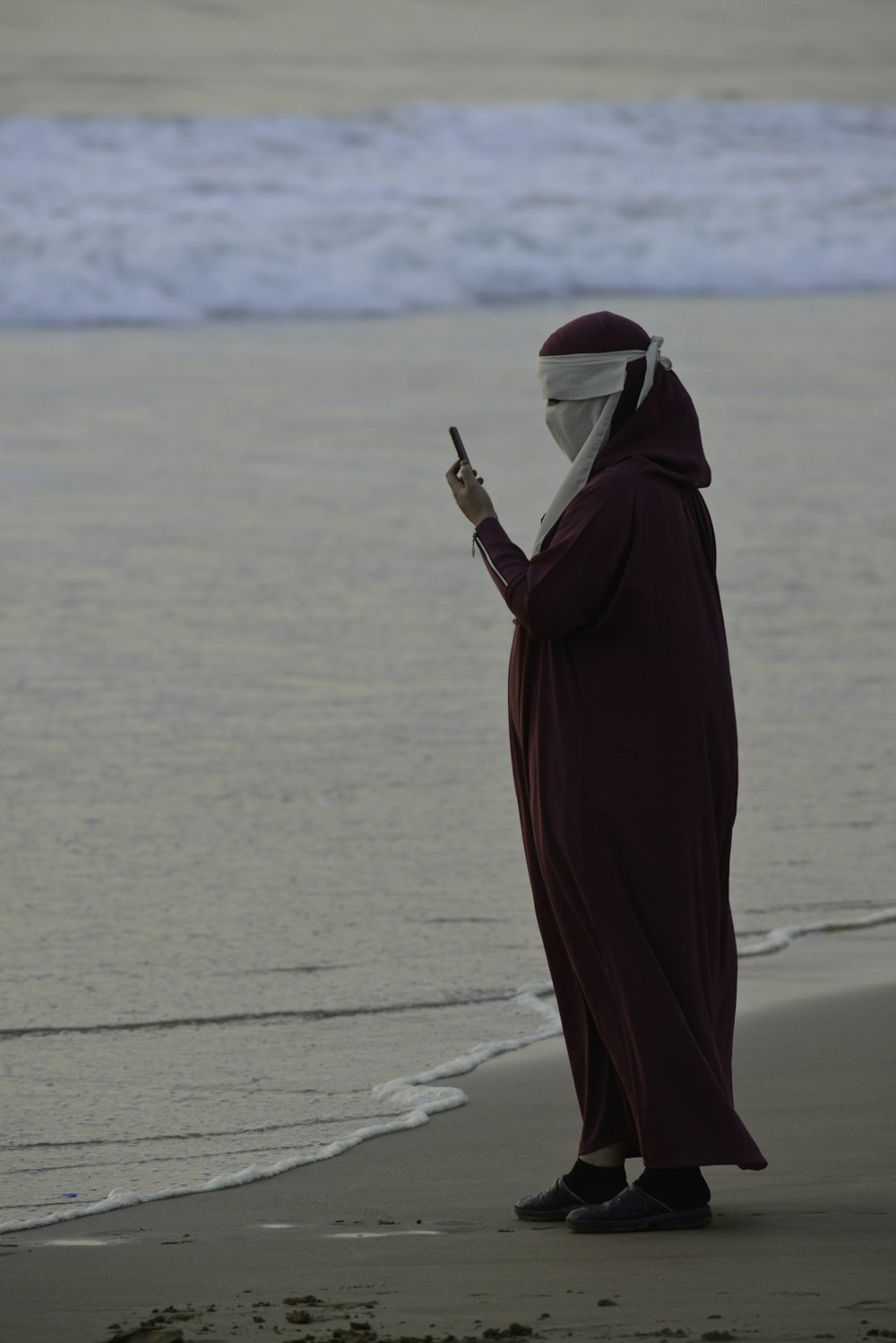 a person in a robe on a beach