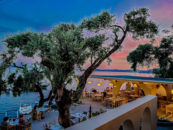 Cozy seaside dining area with warm lighting and rustic decor at Costaluce restaurant.