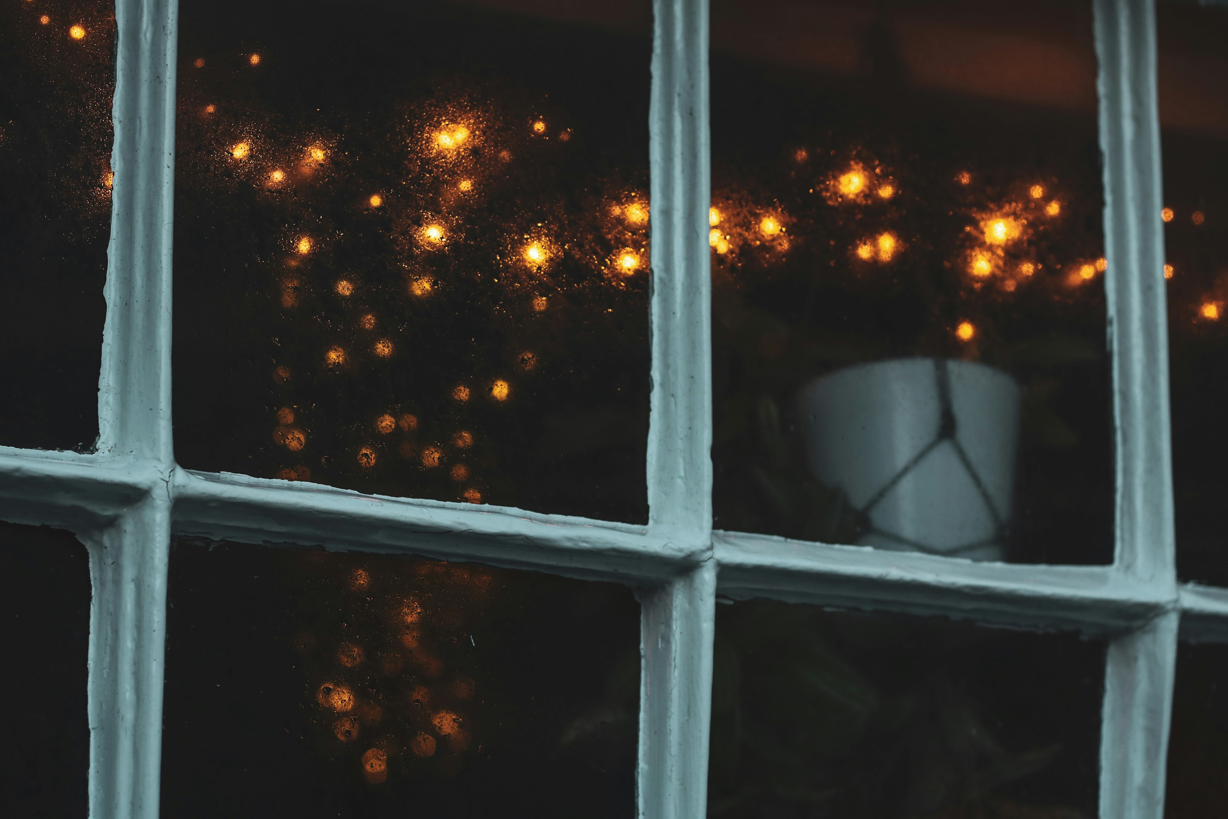 a window with a view of a city at night