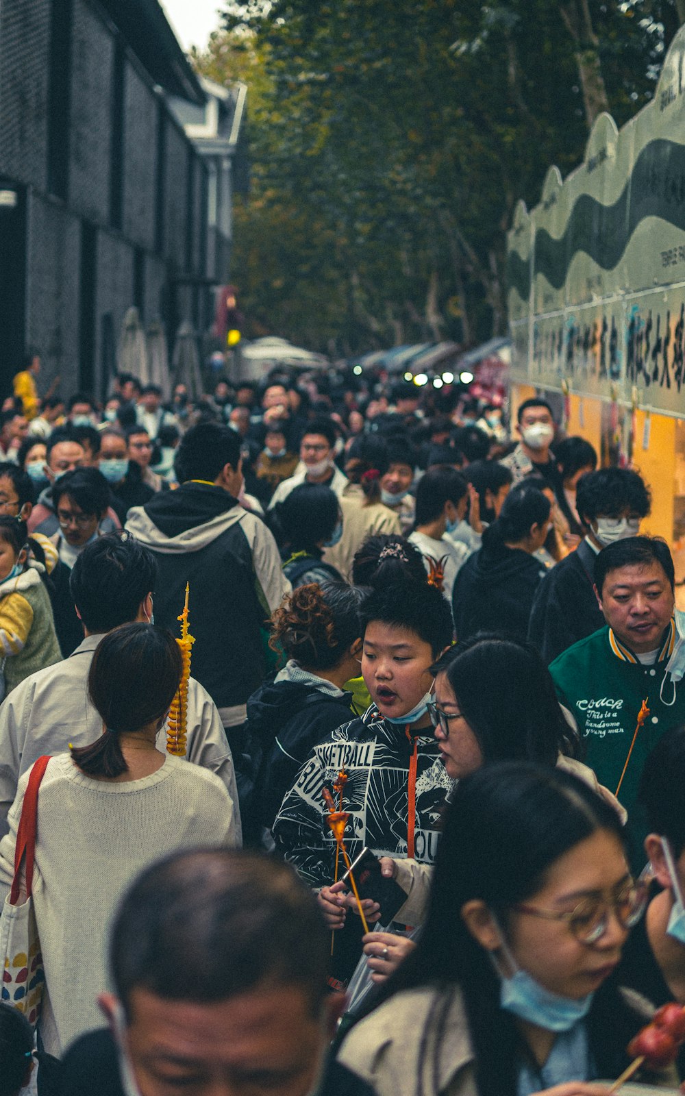 a crowd of people walking down a street