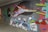Graffiti artwork features human figures in vibrant colors. The central figure appears to be in motion, with exaggerated limbs and a rainbow-like hue. Below, abstract shapes resemble spray paint cans with faces.