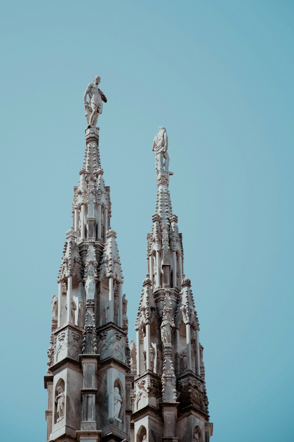 a tall building with statues on top