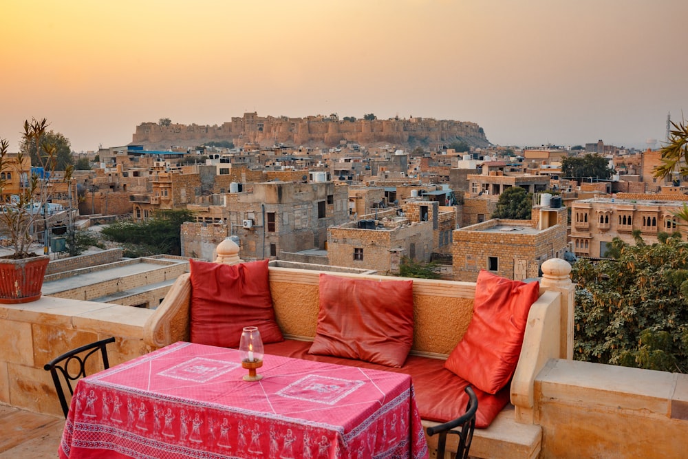 a table and chairs on a balcony overlooking a city