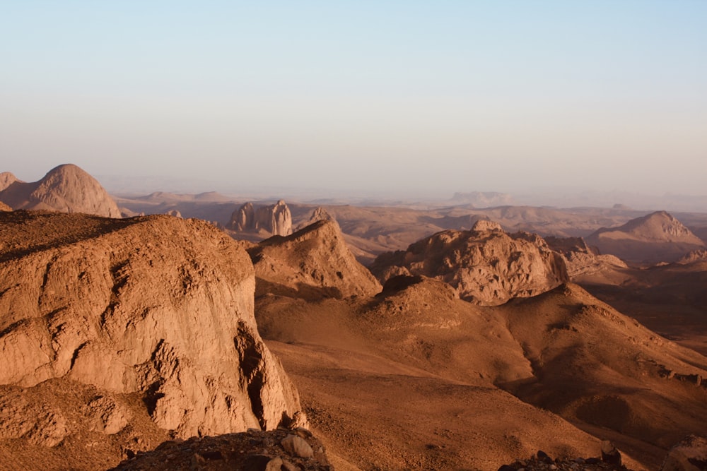 a rocky landscape with a valley in the distance