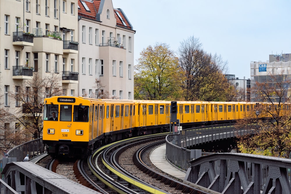 a yellow train on the tracks