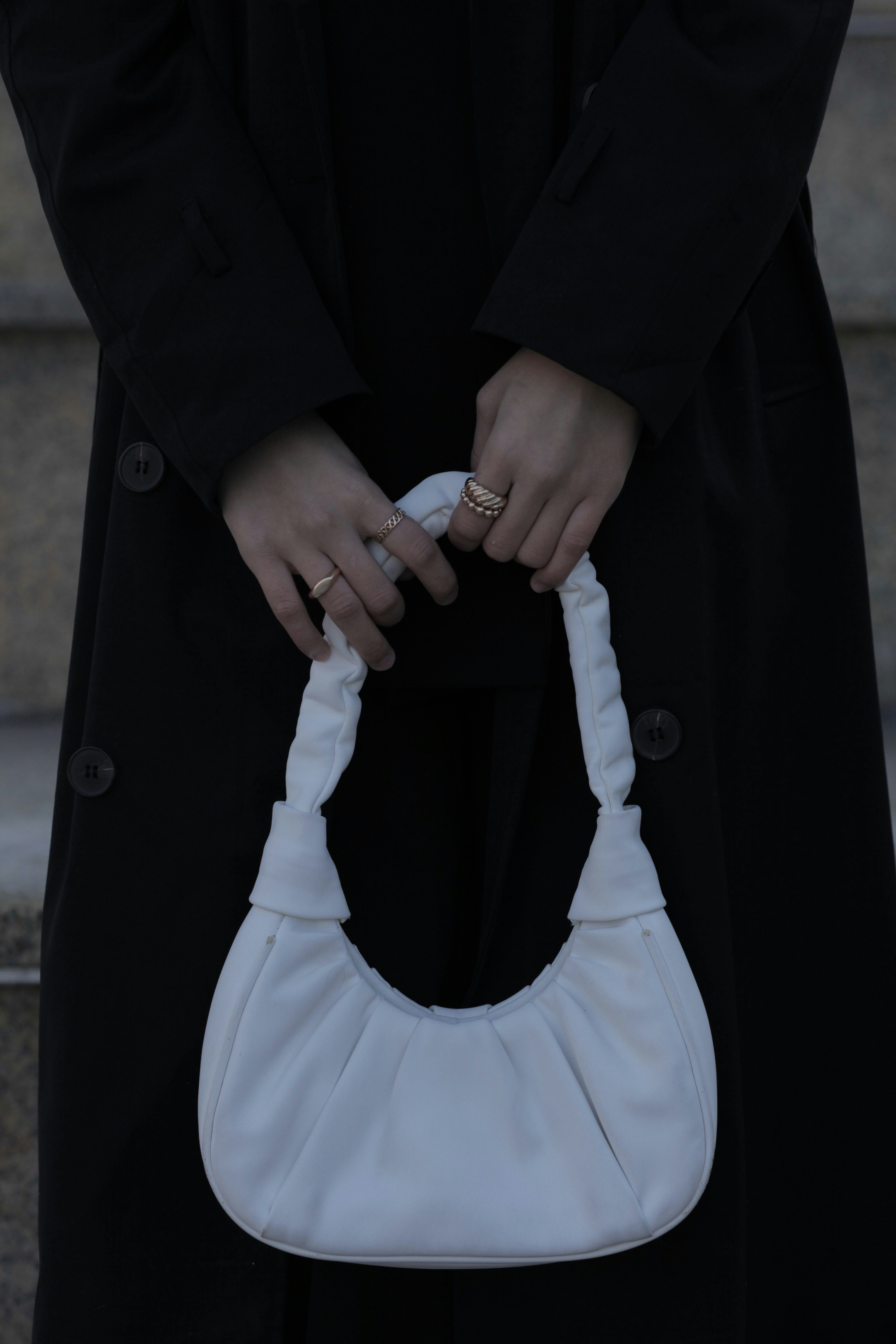 A woman holding a stylish handbag