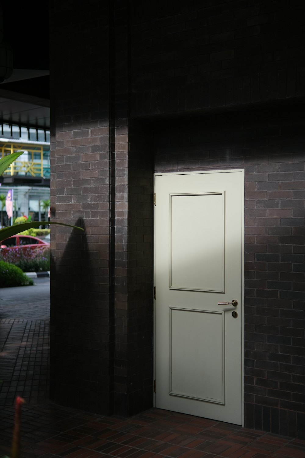 a white door on a brick building