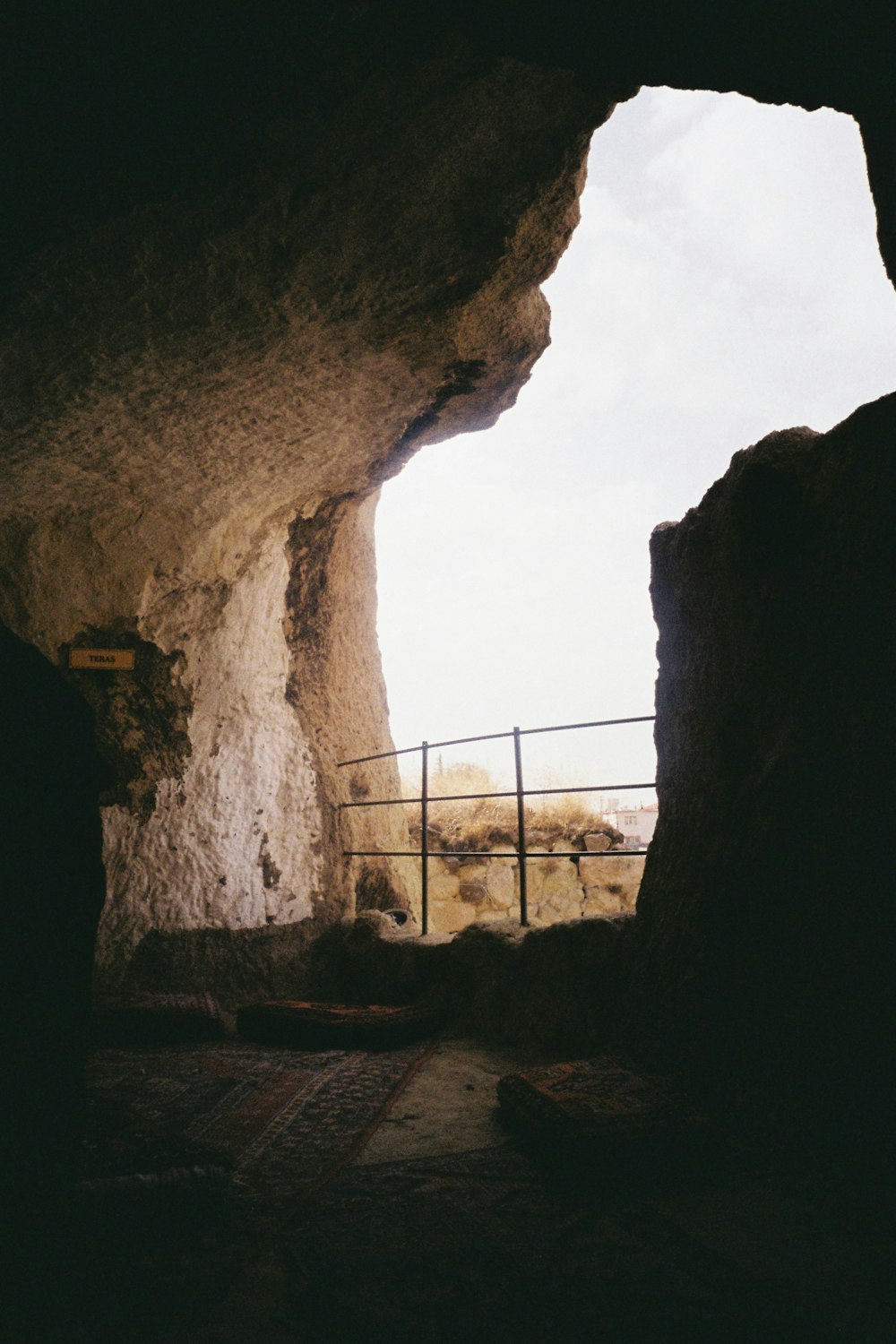 a stone tunnel with a fence