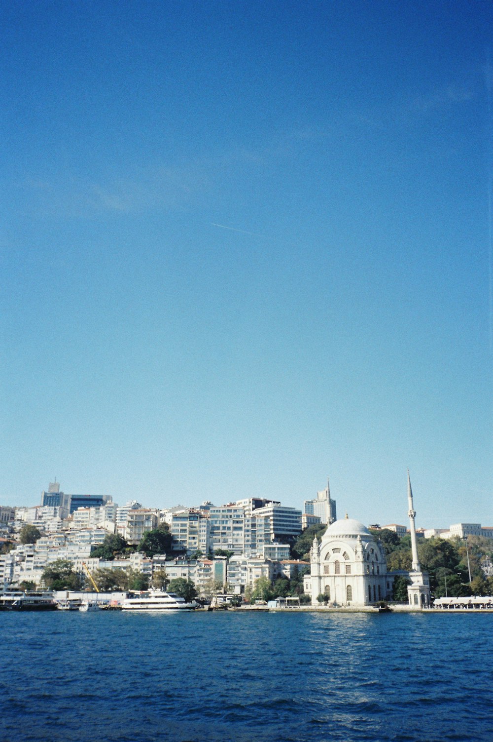 a body of water with a city in the background