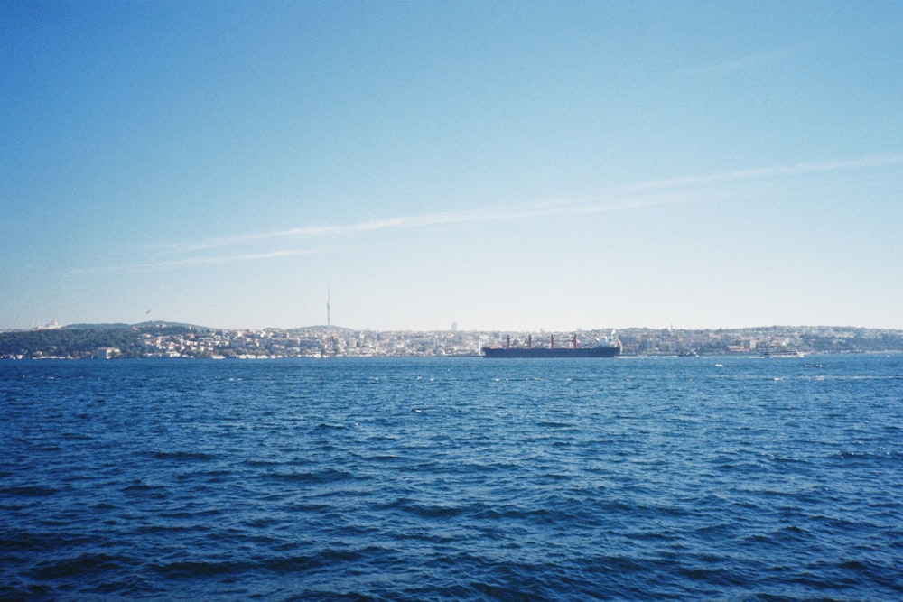 a body of water with a city in the distance