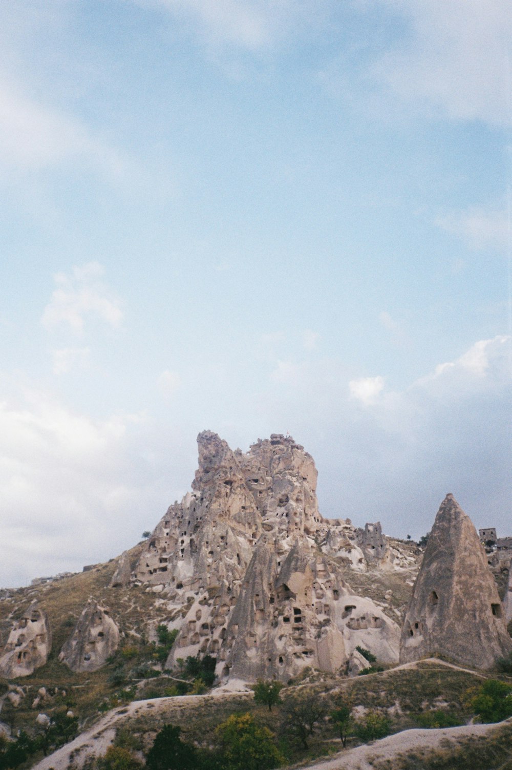 a rocky mountain with a blue sky